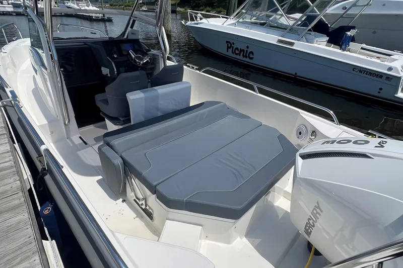  Yacht Photos Pics 2025 Nimbus Tender 8 boat with Mercury engine, featuring spacious seating and modern design.