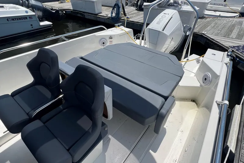  Yacht Photos Pics 2025 Nimbus Tender 8 boat interior with cushioned seating and modern design.