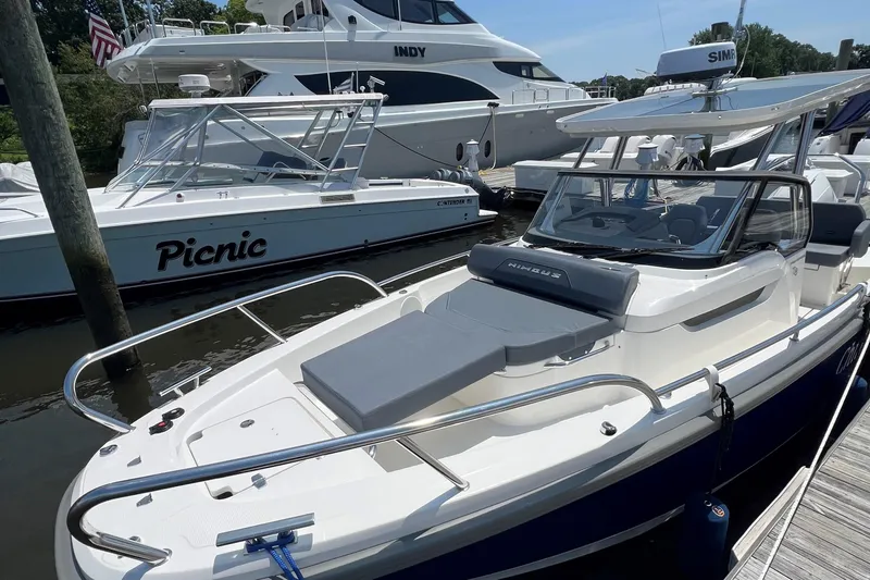  Yacht Photos Pics 2025 Nimbus Tender 8 boat docked, featuring sleek design and comfortable seating.