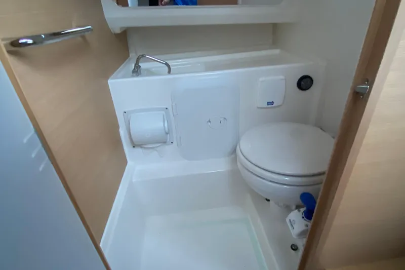  Yacht Photos Pics Compact bathroom in 2025 Nimbus Tender 8 boat, featuring toilet and sink.
