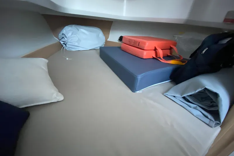  Yacht Photos Pics Cozy cabin interior of 2025 Nimbus Tender 8 with cushions and storage items.