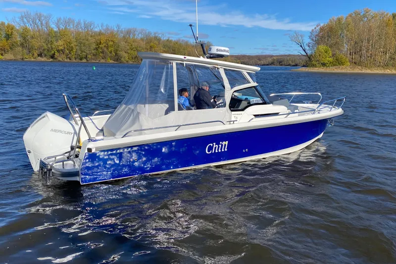  Yacht Photos Pics 2025 Nimbus Tender 8 boat named "Chill" cruising on a scenic lake.