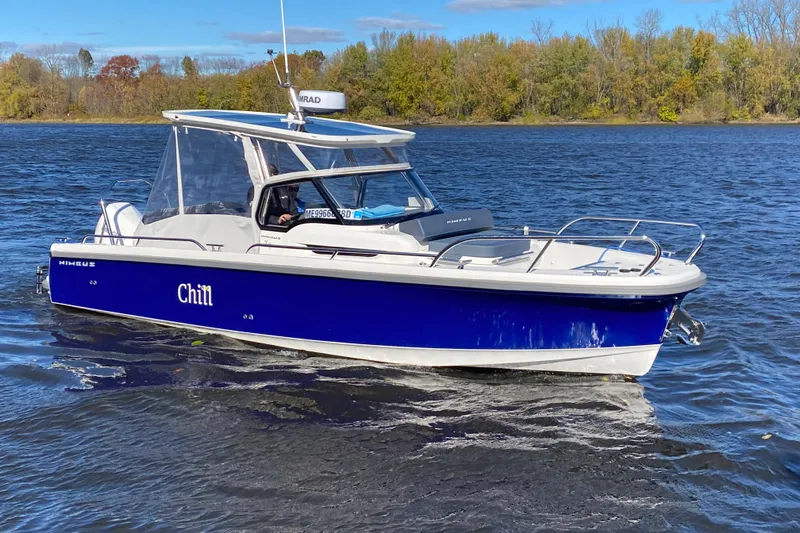  Yacht Photos Pics 2025 Nimbus Tender 8 boat named "Chill" cruising on a scenic lake.