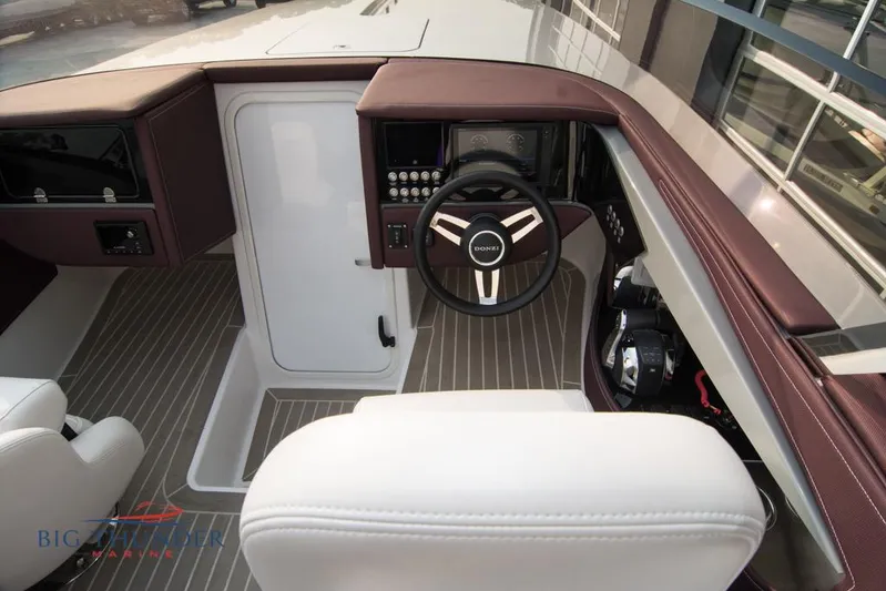  Yacht Photos Pics 2019 Donzi 41 GT boat cockpit with steering wheel and control panel.