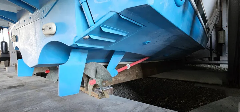 Sunbeam Yacht Photos Pics 2002 Pursuit 3800 Express boat hull in dry dock, supported by wooden blocks.