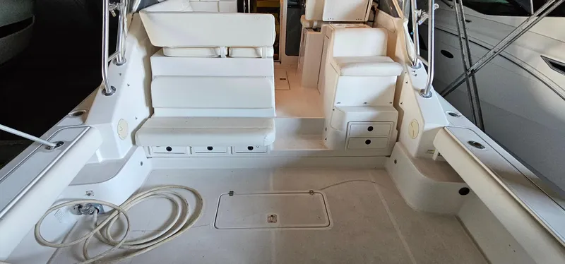 Sunbeam Yacht Photos Pics 2002 Pursuit 3800 Express boat interior with white seating and deck.