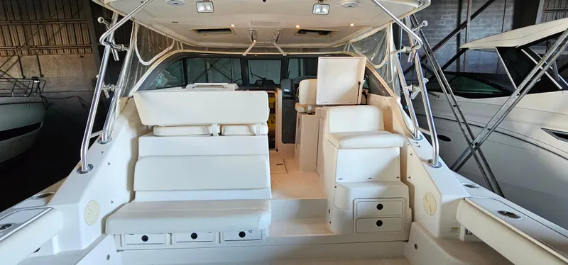 Sunbeam Yacht Photos Pics 2002 Pursuit 3800 Express boat interior with white seating and storage compartments.