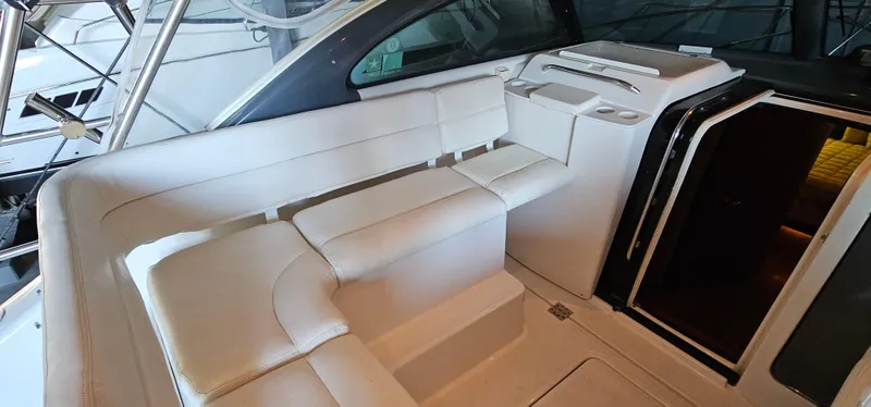 Sunbeam Yacht Photos Pics 2002 Pursuit 3800 Express yacht interior with white seating and cabin entrance.