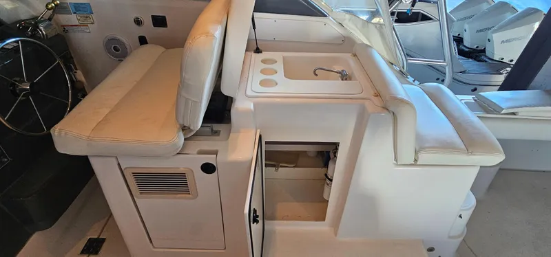 Sunbeam Yacht Photos Pics 2002 Pursuit 3800 Express boat interior with seating and sink area.