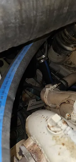 Sunbeam Yacht Photos Pics Close-up of a 2002 Pursuit 3800 Express engine component with visible hoses and fittings.