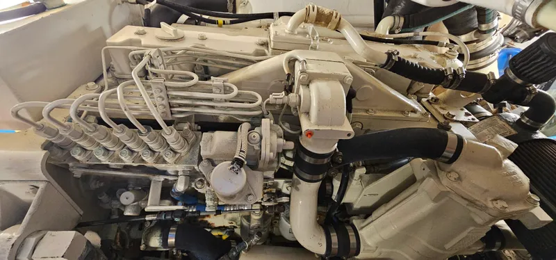 Sunbeam Yacht Photos Pics Engine of a 2002 Pursuit 3800 Express boat, showcasing intricate mechanical components.