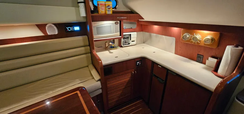 Sunbeam Yacht Photos Pics 2002 Pursuit 3800 Express yacht interior with kitchenette and seating area.
