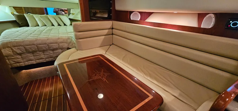 Sunbeam Yacht Photos Pics Interior of 2002 Pursuit 3800 Express yacht with plush seating and elegant wood table.