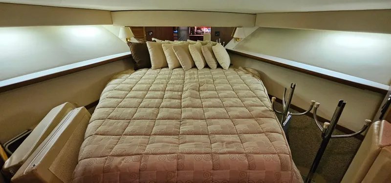 Sunbeam Yacht Photos Pics Luxurious cabin interior of 2002 Pursuit 3800 Express with cozy bedding and ambient lighting.