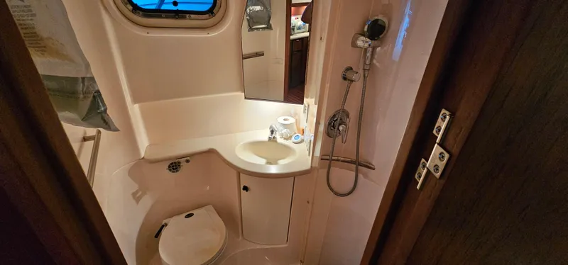 Sunbeam Yacht Photos Pics Bathroom interior of a 2002 Pursuit 3800 Express boat, featuring a compact design.
