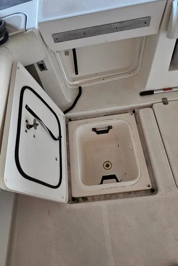 Sunbeam Yacht Photos Pics 2002 Pursuit 3800 Express boat storage compartments with open hatches.