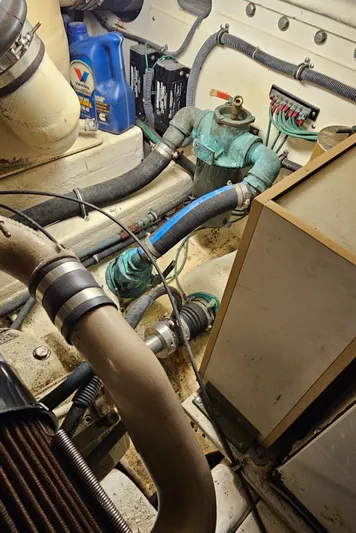 Sunbeam Yacht Photos Pics Engine room of a 2002 Pursuit 3800 Express boat with visible hoses and components.