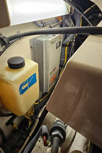 Sunbeam Yacht Photos Pics Engine compartment of a 2002 Pursuit 3800 Express boat, showing wiring and fluid container.