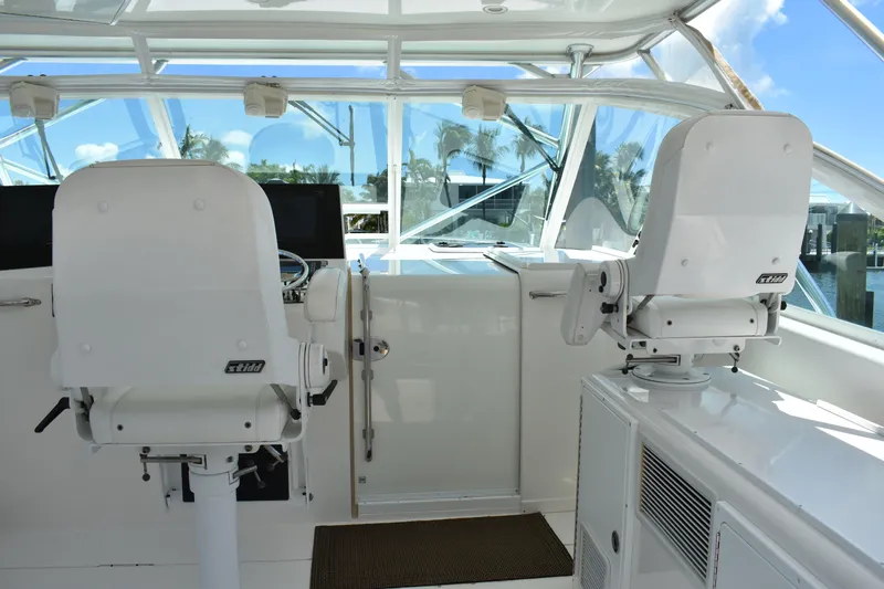 Kraken Yacht Photos Pics 2007 Cabo Express boat helm with white seating and clear windows.