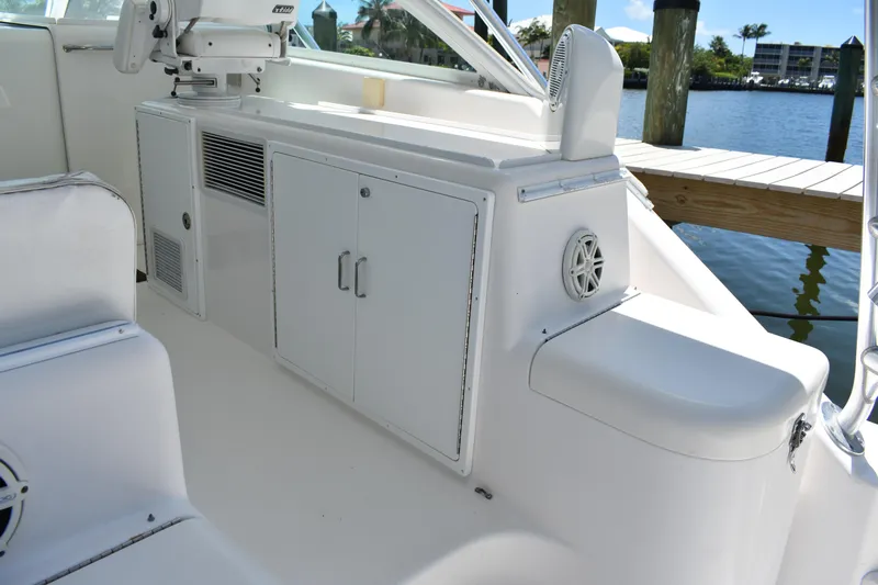 Kraken Yacht Photos Pics 2007 Cabo Express boat interior with white cabinetry and seating by the water.