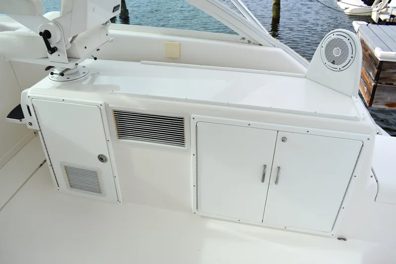 Kraken Yacht Photos Pics 2007 Cabo Express boat interior with storage compartments and speaker, docked by the water.