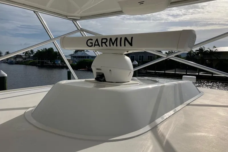 Kraken Yacht Photos Pics 2007 Cabo Express boat with Garmin radar, docked near waterfront homes.