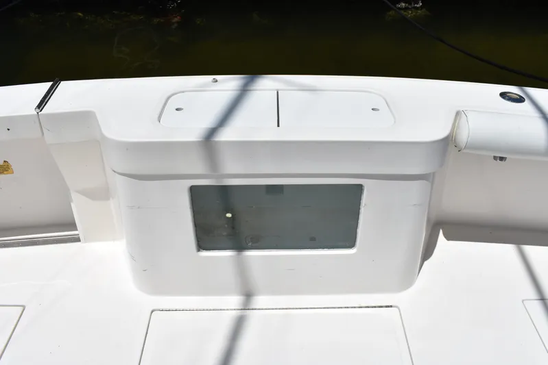 Kraken Yacht Photos Pics 2007 Cabo Express boat deck with storage compartment and clean white surface.
