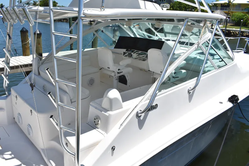 Kraken Yacht Photos Pics 2007 Cabo Express boat with sleek design, spacious cockpit, and modern controls docked by the water.