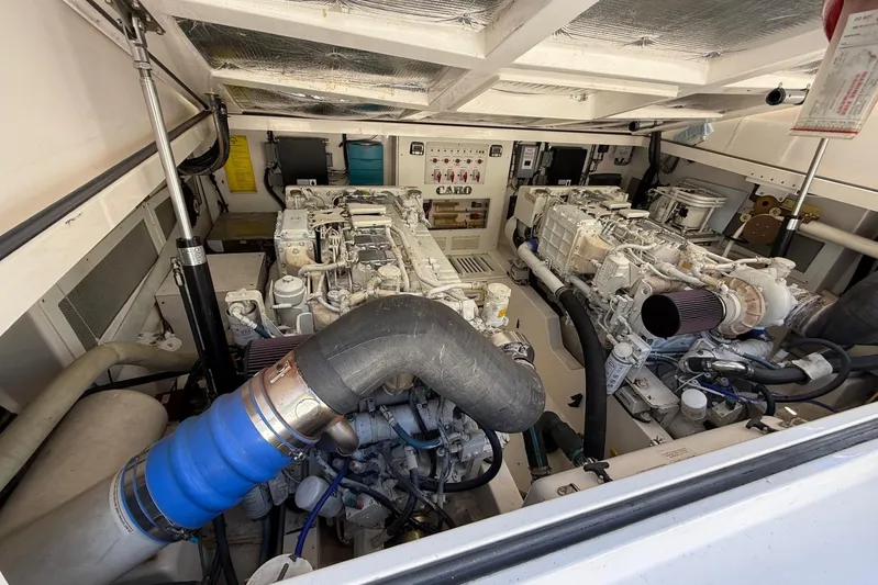 Kraken Yacht Photos Pics Engine room of a 2007 Cabo Express boat, showcasing dual engines and mechanical components.