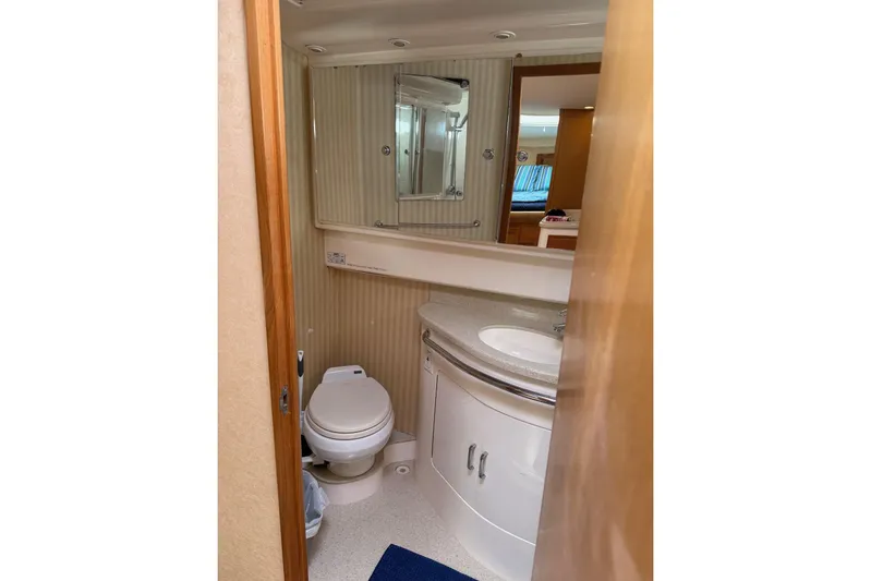 Kraken Yacht Photos Pics 2007 Cabo Express yacht bathroom with toilet, sink, and mirror.