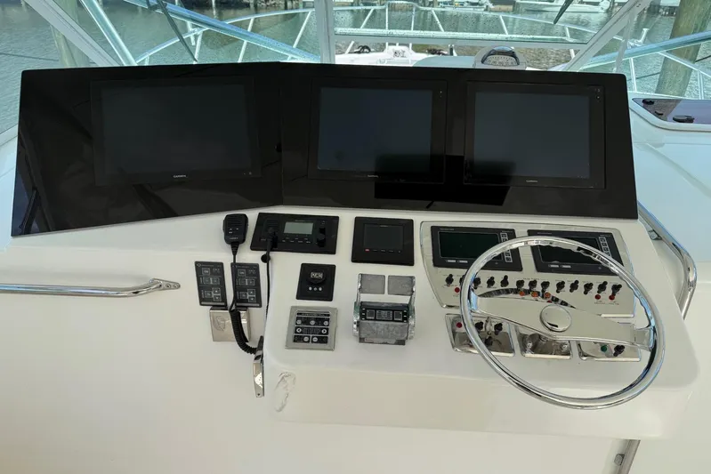 Kraken Yacht Photos Pics 2007 Cabo Express boat helm with multiple screens and control panel.