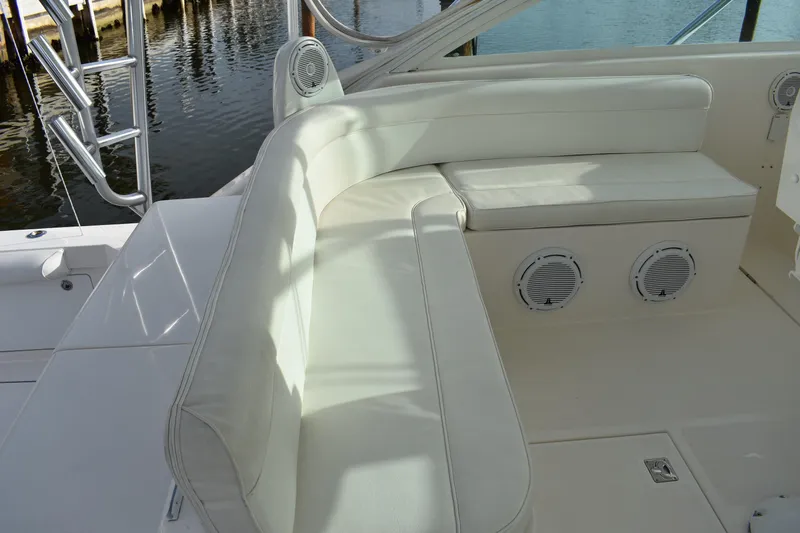 Kraken Yacht Photos Pics 2007 Cabo Express boat interior with white cushioned seating and built-in speakers.