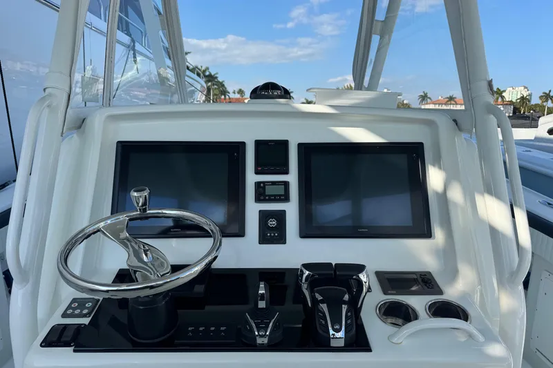  Yacht Photos Pics 2014 Yellowfin 39 Offshore boat dashboard with dual screens and steering wheel.