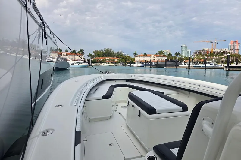  Yacht Photos Pics 2014 Yellowfin 39 Offshore boat docked in a marina with scenic city backdrop.
