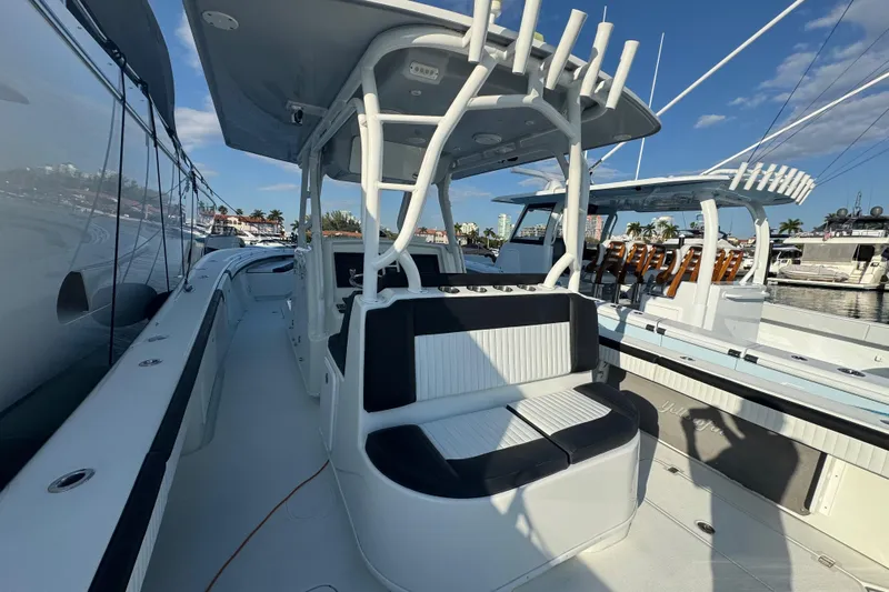  Yacht Photos Pics 2014 Yellowfin 39 Offshore boat with seating, docked under clear blue sky.