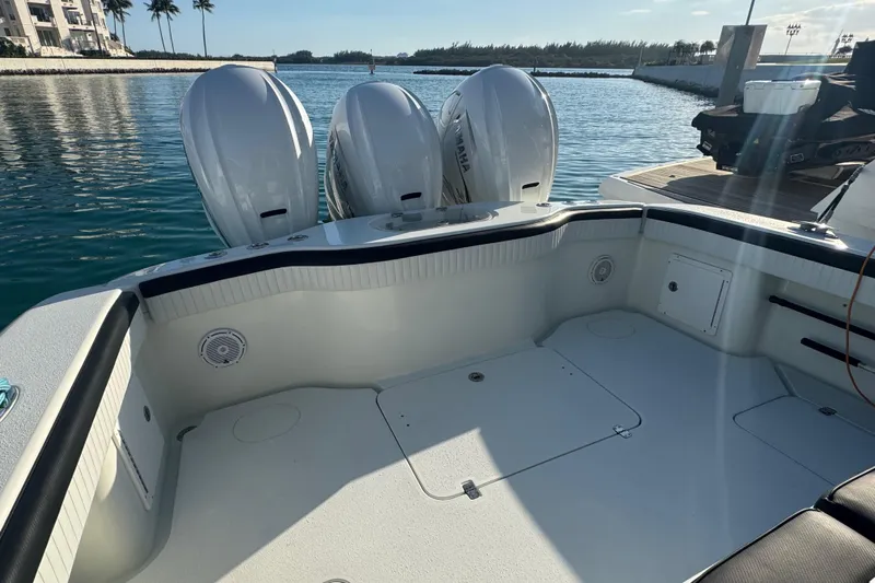  Yacht Photos Pics 2014 Yellowfin 39 Offshore boat with triple Yamaha engines docked in a marina.
