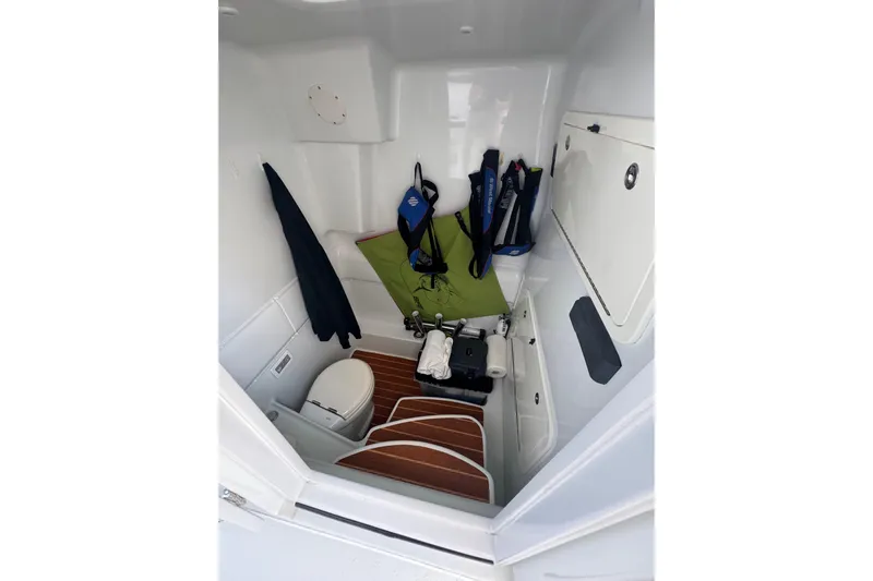  Yacht Photos Pics 2014 Yellowfin 39 Offshore boat interior with toilet, life jackets, and storage space.