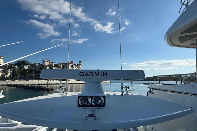  Yacht Photos Pics 2014 Yellowfin 39 Offshore boat with Garmin radar, docked near luxury waterfront homes.