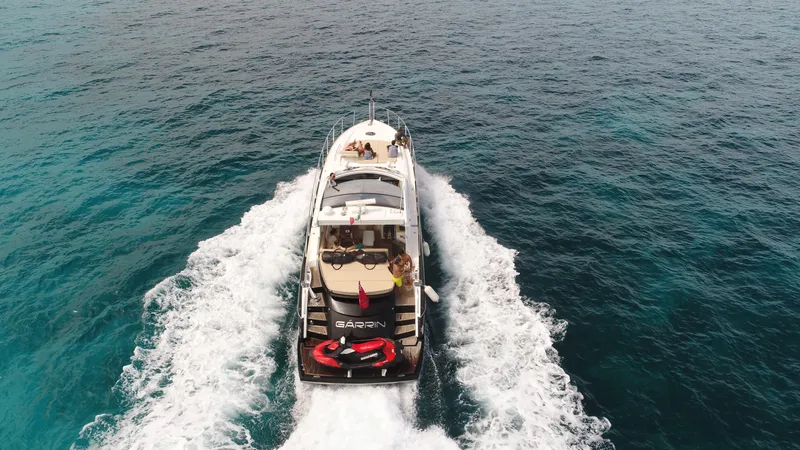 Garrin Yacht Photos Pics Aerial view of 2012 Sunseeker Predator 54 yacht cruising on open water.