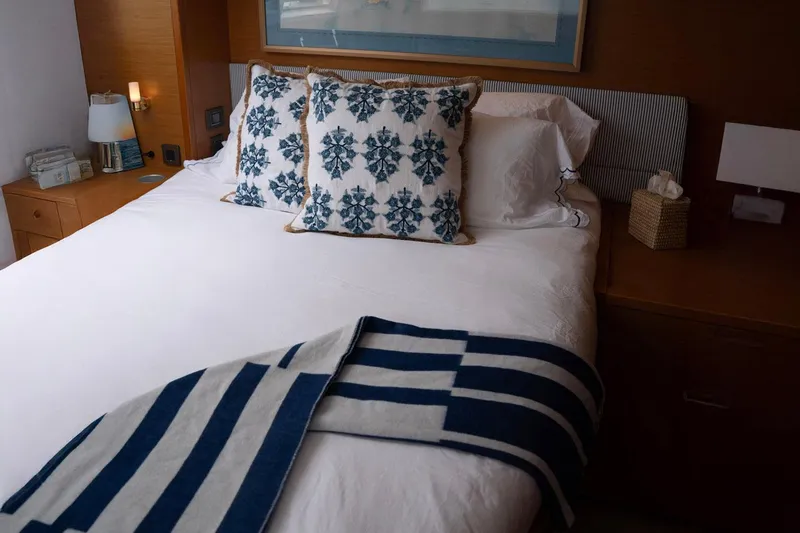 Andromeda Yacht Photos Pics Luxurious bedroom interior on a 2016 Lagoon 620 yacht with elegant bedding and decor.