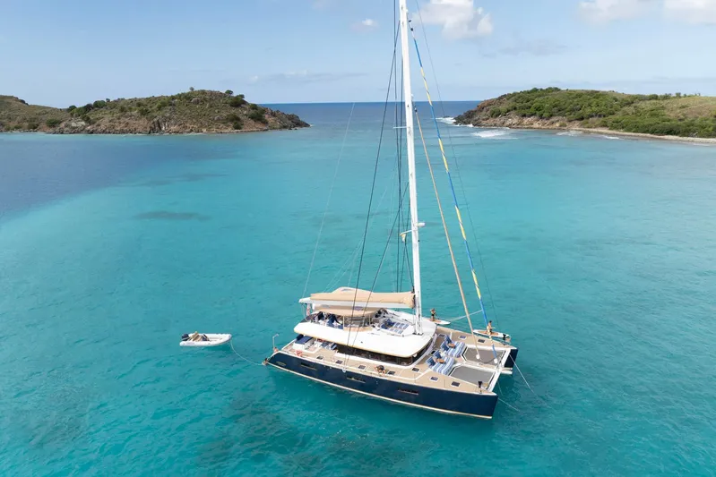 Andromeda Yacht Photos Pics Luxurious 2016 Lagoon 620 catamaran anchored in turquoise waters near scenic islands.
