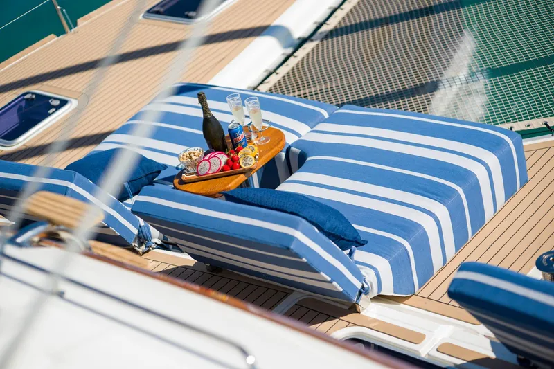 Andromeda Yacht Photos Pics Luxurious Lagoon 620 yacht deck with striped loungers and refreshments, 2016 model.