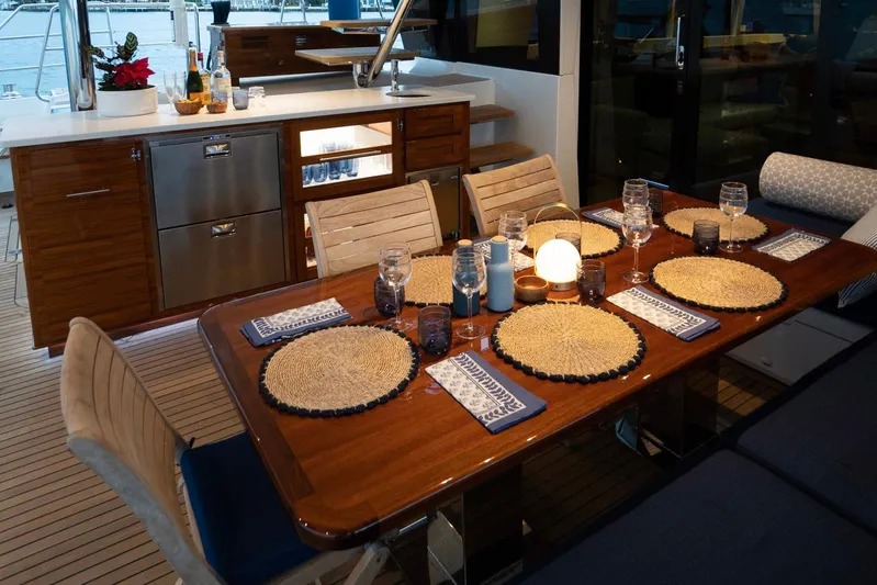 Andromeda Yacht Photos Pics Luxurious dining area on a 2016 Lagoon 620 yacht, elegantly set for dinner.