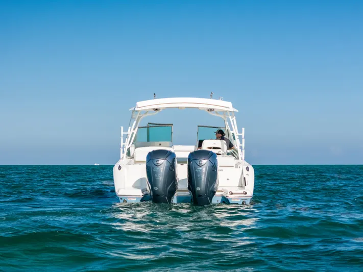 + Sea Keeper 2 Yacht Photos Pics 2024 Cobia 330 Dual Console boat on open water, rear view with twin engines.