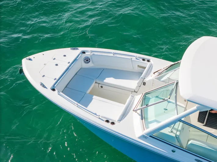 + Sea Keeper 2 Yacht Photos Pics 2024 Cobia 330 Dual Console boat on clear turquoise water.