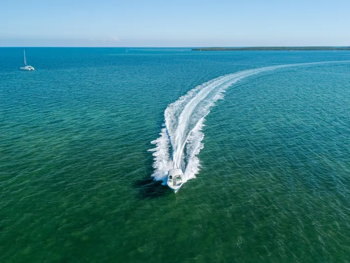 + Sea Keeper 2 Yacht Photos Pics 2024 Cobia 330 Dual Console cruising on open sea, leaving a wake trail.