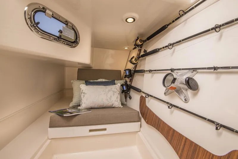  Yacht Photos Pics Manufacturer Provided Image: 2017 Pursuit DC 325 Dual Console cabin with fishing rod storage and cushioned seating.