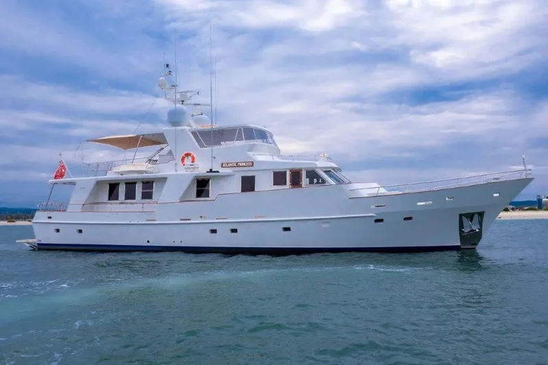 Atlantic Princess Yacht Photos Pics Custom GeTa 86ft Motor Yacht, 1992, cruising on calm waters under a cloudy sky.