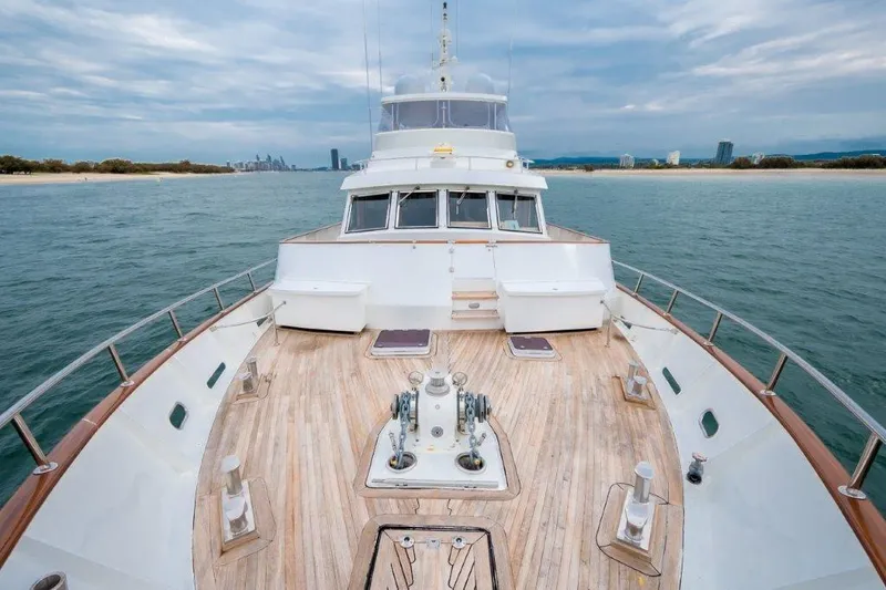 Atlantic Princess Yacht Photos Pics Custom GeTa 86ft Motor Yacht, 1992, cruising on open water with city skyline in background.
