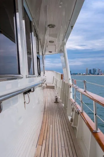 Atlantic Princess Yacht Photos Pics Side deck of 1992 Custom GeTa 86ft Motor Yacht with city skyline view.